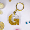 Stylish Golden Glitter Resin Keychain – Elegant "G" Initial